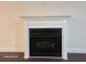 Close up of a fireplace with decorative white trim and contrasting black firebox at 303 Tara Commons Cir, Loganville, GA 30052