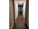 Hallway featuring wood floors connecting to a living space with natural light at 303 Tara Commons Cir, Loganville, GA 30052
