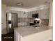 Modern kitchen featuring stainless steel appliances, granite countertops and stylish lighting fixtures at 303 Tara Commons Cir, Loganville, GA 30052