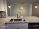 Modern kitchen featuring stainless steel appliances, granite countertops and stylish pendant lighting at 303 Tara Commons Cir, Loganville, GA 30052