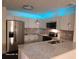 Modern kitchen featuring stainless steel appliances, granite countertops and stylish lighting fixtures at 303 Tara Commons Cir, Loganville, GA 30052