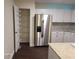 Modern kitchen featuring stainless steel appliances, granite countertops and a pantry with storage shelves at 303 Tara Commons Cir, Loganville, GA 30052