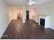 Open-concept living room with dark wood floors and a view to kitchen with lots of space at 303 Tara Commons Cir, Loganville, GA 30052