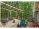 Enjoy the private treed view from this spacious back deck with cafe lights and outdoor furniture at 3861 Riding Sw Trl, Powder Springs, GA 30127