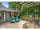 Enjoy a cozy back deck with a pergola, cafe lights, and a lovely outdoor seating area at 3861 Riding Sw Trl, Powder Springs, GA 30127