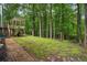 The expansive backyard showcases a treed border and a charming deck, perfect for outdoor enjoyment at 3861 Riding Sw Trl, Powder Springs, GA 30127