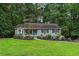 Charming single-story home with blue siding, black shutters, and a well-manicured front yard at 3861 Riding Sw Trl, Powder Springs, GA 30127