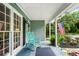 Charming front porch with rocking chair, American flag, and decorative touches for added appeal at 3861 Riding Sw Trl, Powder Springs, GA 30127