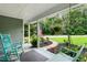 Cozy front porch with a rocking chair, swing, and American flag creating a welcoming atmosphere at 3861 Riding Sw Trl, Powder Springs, GA 30127