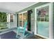 Inviting front porch with swing, rocking chair, and patriotic decorations creating a cozy ambiance at 3861 Riding Sw Trl, Powder Springs, GA 30127