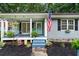 Inviting front porch with swing, rocking chair, and patriotic decor creates a warm welcome at 3861 Riding Sw Trl, Powder Springs, GA 30127