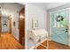 Charming hallway with hardwood floors, quaint desk and view of the front door at 3861 Riding Sw Trl, Powder Springs, GA 30127