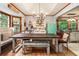 Sunlit kitchen boasts a farmhouse table with seating and an adjacent vintage refrigerator at 3861 Riding Sw Trl, Powder Springs, GA 30127