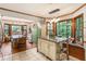 Open kitchen layout with granite island, stainless appliances, vintage fridge, and natural light at 3861 Riding Sw Trl, Powder Springs, GA 30127