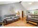 Cozy living room with comfortable seating and hardwood flooring throughout at 3861 Riding Sw Trl, Powder Springs, GA 30127