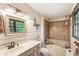 Charming main bathroom featuring an integrated shower and soaking tub, and a large window at 3861 Riding Sw Trl, Powder Springs, GA 30127