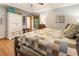 Spacious main bedroom featuring wood floors, a ceiling fan, and a large closet for ample storage at 3861 Riding Sw Trl, Powder Springs, GA 30127