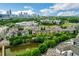 Aerial view of community including a pond, apartments, and the Atlanta skyline at 400 17Th Nw St # 2412, Atlanta, GA 30363