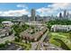 Panoramic aerial view of the property, showcasing its proximity to nearby attractions, green space, and a tranquil pond at 400 17Th Nw St # 2412, Atlanta, GA 30363