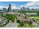 Aerial view of a community with apartments, trees, and the city skyline in the background at 400 17Th Nw St # 2412, Atlanta, GA 30363