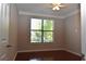 Bedroom with hardwood floors, a ceiling fan, and a large window with blinds at 400 17Th Nw St # 2412, Atlanta, GA 30363