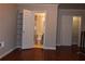 Hallway area with bathroom, large door frame, and closet access, featuring hardwood flooring at 400 17Th Nw St # 2412, Atlanta, GA 30363