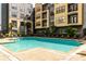 Beautiful community pool with lounge seating, surrounded by modern buildings at 400 17Th Nw St # 2412, Atlanta, GA 30363