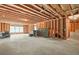 Unfinished basement with exposed framing, concrete floor, and natural light from windows at 4110 Morgan Elizabeth Way, Cumming, GA 30041