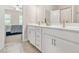 Bathroom featuring double sink vanity with drawers and gold hardware with view to bedroom at 4110 Morgan Elizabeth Way, Cumming, GA 30041