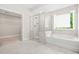 Bright bathroom features a glass shower, tub, and walk-in closet at 4110 Morgan Elizabeth Way, Cumming, GA 30041
