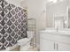 Bathroom featuring shower/tub, patterned curtain, toilet, and vanity with framed mirror at 4110 Morgan Elizabeth Way, Cumming, GA 30041