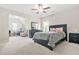 Bedroom featuring plush carpet, ceiling fan and large black bed frame with night stands at 4110 Morgan Elizabeth Way, Cumming, GA 30041