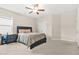 Bedroom featuring plush carpet, ceiling fan and large black bed frame with night stands at 4110 Morgan Elizabeth Way, Cumming, GA 30041