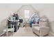 Bonus room featuring vaulted ceilings, plush chair and space themed decorations at 4110 Morgan Elizabeth Way, Cumming, GA 30041