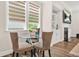 Bright breakfast nook features a glass table, neutral colors, and plenty of natural light at 4110 Morgan Elizabeth Way, Cumming, GA 30041