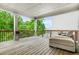 Inviting wooden deck with a comfortable outdoor sofa and views of lush greenery at 4110 Morgan Elizabeth Way, Cumming, GA 30041