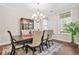 Elegant dining room featuring a chandelier, large window, and dark wood flooring at 4110 Morgan Elizabeth Way, Cumming, GA 30041