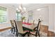 Elegant dining room with a large table, chandelier, and a neutral color palette at 4110 Morgan Elizabeth Way, Cumming, GA 30041