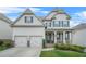 Charming two-story home with a welcoming front porch and a well-manicured front yard at 4110 Morgan Elizabeth Way, Cumming, GA 30041