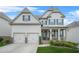 Charming two-story home with a welcoming front porch and a well-manicured front yard at 4110 Morgan Elizabeth Way, Cumming, GA 30041