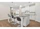 Gourmet kitchen features stainless steel appliances and a granite countertop island with barstool seating at 4110 Morgan Elizabeth Way, Cumming, GA 30041