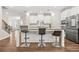Gourmet kitchen features stainless steel appliances and a granite countertop island with barstool seating at 4110 Morgan Elizabeth Way, Cumming, GA 30041