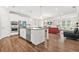 Open concept living room and kitchen with stainless steel appliances, and hardwood floors at 4110 Morgan Elizabeth Way, Cumming, GA 30041