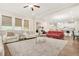 Spacious living room with sofas, a ceiling fan, and an open layout to the kitchen at 4110 Morgan Elizabeth Way, Cumming, GA 30041