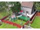 Aerial view reveals a fenced backyard with patio, deck, and a storage shed at 914 Wenham Ln, Lawrenceville, GA 30044