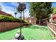 Fenced backyard featuring a storage shed, basketball hoop, and well-manicured landscaping at 914 Wenham Ln, Lawrenceville, GA 30044