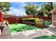Fenced backyard boasts artificial grass and basketball hoop for Gathering fun at 914 Wenham Ln, Lawrenceville, GA 30044
