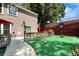 Backyard view features a privacy fence, patio with a grill, artificial turf and basketball hoop at 914 Wenham Ln, Lawrenceville, GA 30044