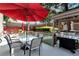 Outdoor living space featuring patio dining set, grill, and red umbrella at 914 Wenham Ln, Lawrenceville, GA 30044