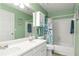 Bathroom featuring double sinks, tub with shower, and nautical-themed decor at 914 Wenham Ln, Lawrenceville, GA 30044